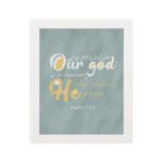 Christian wall art with Psalm 115:3 verse in gold and white text, set against a light sage green background, with elegant script fonts. hung on the wall in a white frame