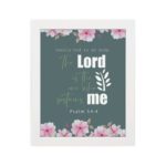 Surely God is my help Psalm 54:4 Bible verse wall art with bold and cursive fonts, floral accents, and a dark green background. hung on the wall in a white frame