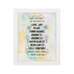 Fruit of the Spirit Bible verse wall art with black text and pastel watercolor background, Galatians 5:22-23. hung on the wall in a white frame