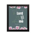 Surely God is my help Psalm 54:4 Bible verse wall art with bold and cursive fonts, floral accents, and a dark green background. hung on the wall in a black frame