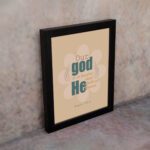 Psalm 115:3 Bible verse wall art with bold teal and orange text, blue highlights, and a soft beige background with a floral accent. displayed on the wall in a black frame