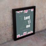 Surely God is my help Psalm 54:4 Bible verse wall art with bold and cursive fonts, floral accents, and a dark green background. displayed on the wall in a black frame