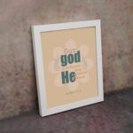 Psalm 115:3 Bible verse wall art with bold teal and orange text, blue highlights, and a soft beige background with a floral accent. displayed on the wall in a white frame