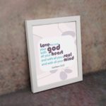 Love the Lord your God with all your heart, soul, and mind Matthew 22:37 Bible Wall Art with purple and teal text, abstract shapes, and leaf motifs on light cream background displayed on the wall in a white frame