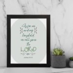 Christian wall art featuring Joshua 24:15 Bible verse on a gray and white background with gray design and green font and black framed displayed on the wall