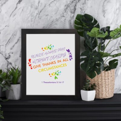 Rejoice always, pray without ceasing, give thanks in all circumstances 1 Thessalonians 5:16-17 Bible Wall Art with vibrant purple, orange, and green colors, floral accents displayed on the table