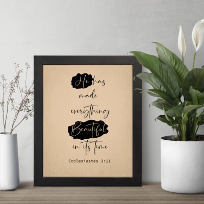 Infidu Bible Wall Art with beige background, black handwritten-style text, and bold "Beautiful" from Ecclesiastes 3:11. displayed on the table in a black frame