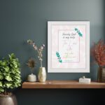 Psalm 54:4 Bible verse wall art with simple fonts, pink highlights, leafy decorations, and a light background. displayed on the wall in a white frame