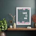 Surely God is my help Psalm 54:4 Bible verse wall art with bold and cursive fonts, floral accents, and a dark green background. displayed on the wall in a white frame