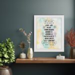 Fruit of the Spirit Bible verse wall art with black text and pastel watercolor background, Galatians 5:22-23. displayed on the wall in a white frame