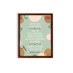 Christian wall art with Galatians 5:22-23 Bible verse on a light green background with light pink, brown, and green leaf design and brown frame hung on the wall