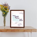 Love the Lord your God with all your heart, soul, and mind Matthew 22:37 Bible Wall Art with purple and teal text, abstract shapes, and leaf motifs on light cream background displayed on the table