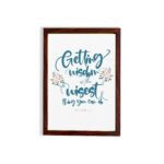 Proverbs 4:7 Christian wall art with elegant script and floral design, featuring Getting Wisdom Is The Wisest Thing You Can Do. hung on the wall in a brown frame