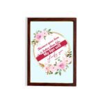 Beautiful wall art with the quote Because your love is better than life from Psalm 63:3, featuring a floral design on a light blue background. hung on the wall in a brown frame