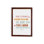 Bible wall art with Acts 2:21 verse, featuring pastel polka dots and bold text, designed to inspire and uplift your home decor. hung on the wall in a brown frame