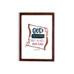 Wall art with the text 'God Is Within Her, She Will Not Fall' in colorful fonts, surrounded by pink blossoms and a wooden frame. hung on the wall in a brown frame