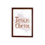 Jesus Christ Bible wall art with hand-drawn brown lettering and a minimalist white-gray watercolor background in a black frame. hung on the wall in a brown frame