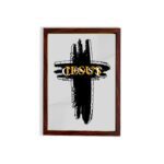 Infidu Jesus Christ Bible Wall Art featuring a black cross and gold lettering on a light gray background. Perfect for home decor. hung on the wall in a brown frame