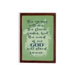 Christian wall art featuring Isaiah 40:8 with dark green and black text on a light green background. hung on the wall in a brown frame