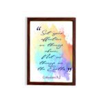 Bible wall art featuring Colossians 3:2 in cursive text on a colorful rainbow background. hung on the wall in a brown frame