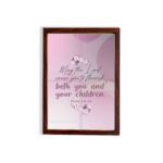 Christian wall art with the verse May The Lord Cause You To Flourish Both You And Your Children Psalm 115:14 in soft colors and floral design. hung on the wall in a brown frame