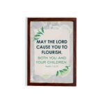 Infidu Christian wall art featuring Psalm 115:14 with bold text, green highlights, and leaf designs on a light gray background. hung on the wall in a brown frame