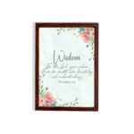 Christian wall art with Proverbs 2:6, featuring "Wisdom" and floral accents on a cream background. hung on the wall in a brown frame