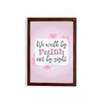 Christian wall art displaying We Walk By Faith Not By Sight with floral elements on a pale pink background. hung on the wall in a brown frame