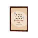 Christian wall art with the phrase "Your Right Hand Upholds Me" Psalm 63:8, featuring bold text and floral accents on a peach background. hung on the wall in a brown frame