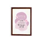 Christian wall art featuring the quote Getting Wisdom Is The Wisest Thing You Can Do from Proverbs 4:7, with pink flowers and soft colors. hung on the wall in a brown frame