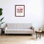 Bible wall art featuring The Lord Is My Rock, My Fortress, and My Deliverer in black handwritten-style lettering on a soft pink watercolor background. displayed on the wall in a brown frame