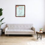 Cast Your Burden on the Lord Psalm 55:22 Christian wall art with teal and coral text on a mint green background with floral accents. displayed on the wall in a brown frame