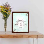 Because Your Love Is Better Than Life Psalm 63:3 Bible Verse Wall Art with soft blue background and floral accents. displayed on the table in a brown frame