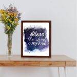 Bless The Lord O My Soul Psalm 103:1 Christian wall art with white text on a deep blue watercolor background. displayed on the table in a brown frame