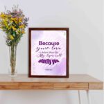 Bible wall art featuring Psalm 63:3 with playful text in purple and pink on a lavender background. displayed on the table in a brown frame