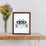 Infidu Bible wall art featuring the quote With God Nothing Shall Be Impossible in navy blue text on a light blue watercolor background. displayed on the table in a brown frame