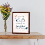 Bible verse wall art displaying From the Rising of the Sun to the Place Where It Sets, The Name of the Lord Is to Be Praised. displayed on the table in a brown frame