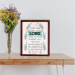 Cast Your Burden on the Lord Psalm 55:22 Christian Wall Art with palm leaf accents and turquoise text on a beige background. displayed on the table in a brown frame