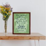 Christian wall art featuring Isaiah 40:8 with dark green and black text on a light green background. displayed on the table in a brown frame