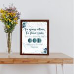 Christian wall art with the verse from Isaiah 40:8, featuring floral details and a textured white background. displayed on the table in a brown frame