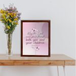 Christian wall art with the verse May The Lord Cause You To Flourish Both You And Your Children Psalm 115:14 in soft colors and floral design. displayed on the table in a brown frame