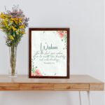 Christian wall art with Proverbs 2:6, featuring "Wisdom" and floral accents on a cream background. displayed on the table in a brown frame