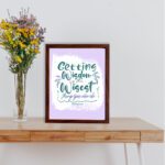 Christian wall art with Getting Wisdom Is The Wisest Thing You Can Do Proverbs 4:7, green text, light purple background, and decorative swirls. displayed on the table in a brown frame