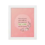 And Everyone Who Calls On The Name Of The Lord Will Be Saved Acts 2:21 Bible Verse Wall Art with pink flowers and soft pink background. hung on the wall in a white frame