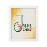 Jesus Christ text in green script with red floral accents on a glowing yellow-orange background, framed in black. hung on the wall in a white frame