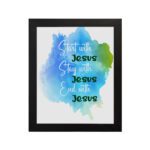 Bible wall art featuring the phrases Start With Jesus, Stay With Jesus, and End With Jesus in cursive on a watercolor blue and green background. hung on the wall in a black frame