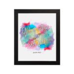 Infidu wall art featuring vibrant watercolor background and the text God Is Within Her She Will Not Fall Psalm 46:5. hung on the wall in a black frame