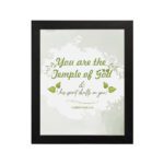 Christian wall art featuring 'You Are The Temple of God His Spirit Dwells in You' from 1 Corinthians 3:16 with green and gray design. hung on the wall in a black frame