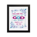 Infidu You Are The Temple Of God 1 Corinthians 3:16 Bible Wall Art with watercolor flowers and bold scripture design hung on the wall in a black frame