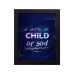 Infidu I Am A Child Of God wall art featuring soft glowing text in pink and blue on a dark blue background. hung on the wall in a black frame